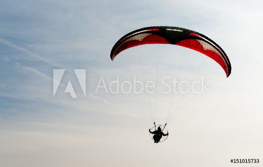 Picture of One Man Rides Flies Ultralight Flying Through Blue Sky